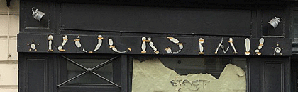 Detail of lost shopfront lettering in Paris.