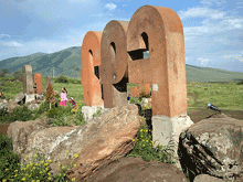 Monumental letters on the hillside facing Mount Aragats