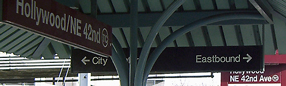 Close-up of directional signs at MAX station in Portland, Oregon.
