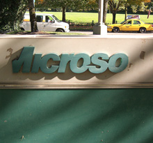 Crumbling logo on the back side of a sign outside a Microsoft building